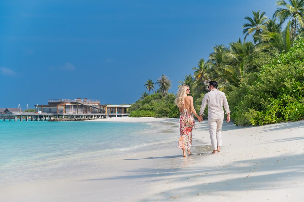Couple walking along the beach